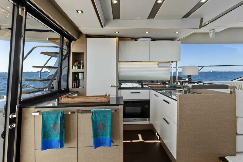 Radiant Yacht Photos Pics Luxurious kitchen interior of 2019 Prestige 630 Flybridge yacht with ocean view.