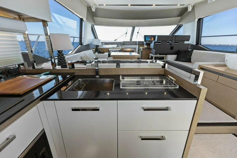 Radiant Yacht Photos Pics Luxurious interior of 2019 Prestige 630 Flybridge yacht with modern kitchen and ocean view.
