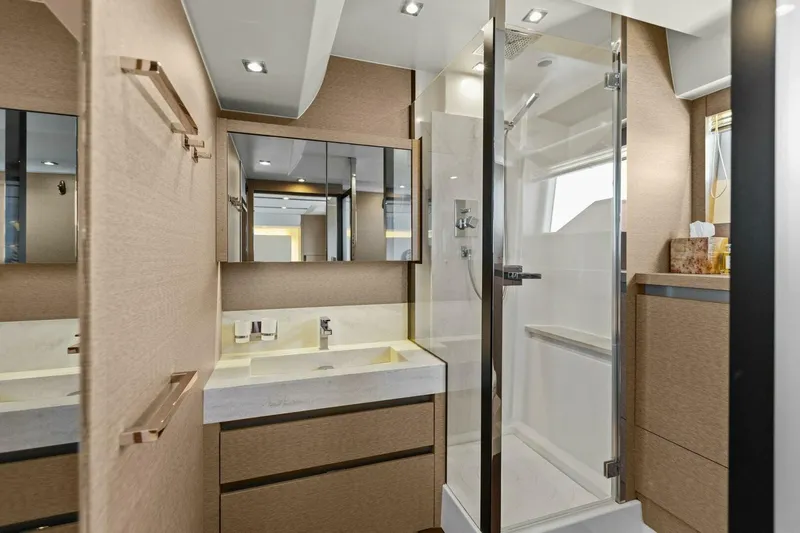 Radiant Yacht Photos Pics Luxurious bathroom in 2019 Prestige 630 Flybridge yacht with modern fixtures and glass shower.
