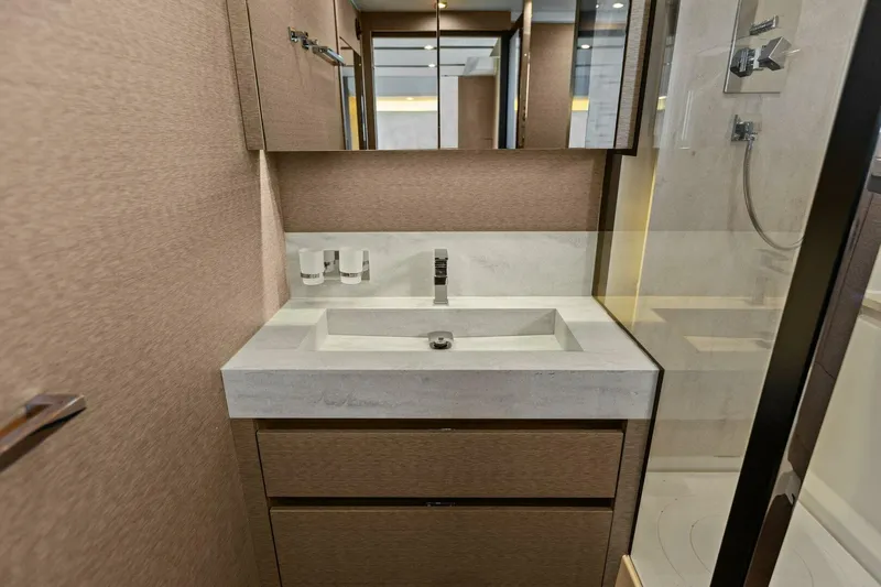 Radiant Yacht Photos Pics Luxurious bathroom interior of 2019 Prestige 630 Flybridge yacht with modern sink and fixtures.