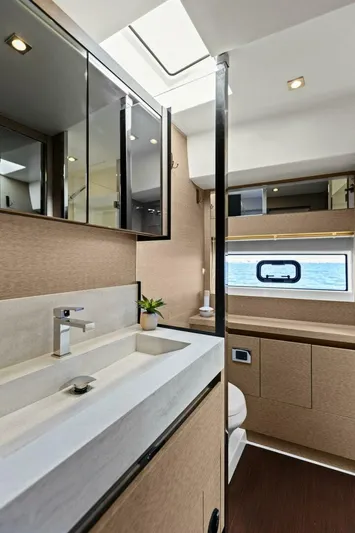 Radiant Yacht Photos Pics Luxurious bathroom interior of 2019 Prestige 630 Flybridge yacht with modern fixtures.