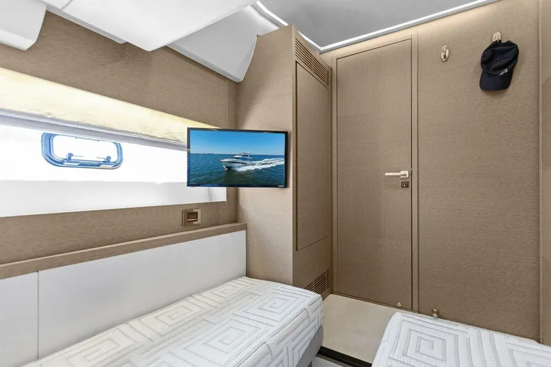 Radiant Yacht Photos Pics Luxurious interior of 2019 Prestige 630 Flybridge yacht cabin with TV and modern decor.