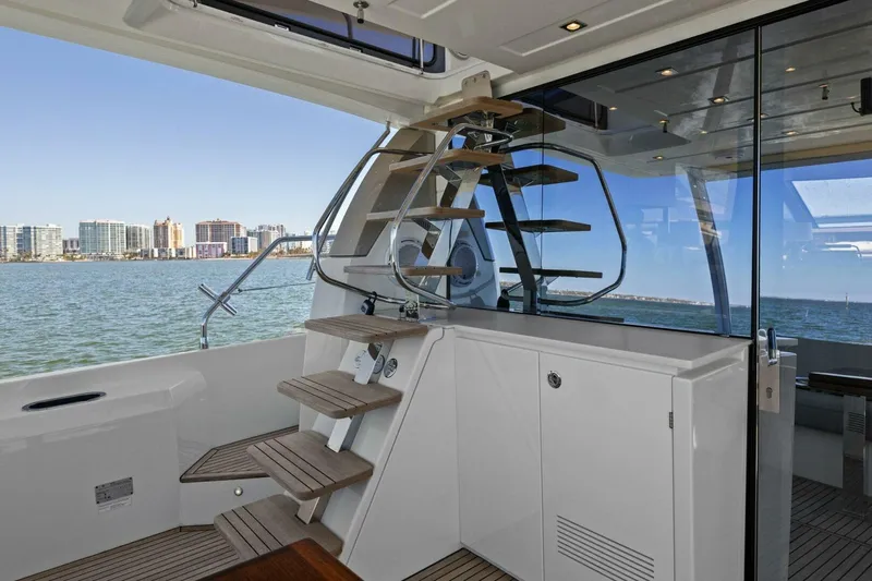 Radiant Yacht Photos Pics Prestige 630 Flybridge 2019 yacht interior with modern staircase and ocean view.