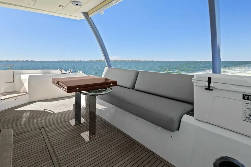 Radiant Yacht Photos Pics Luxurious 2019 Prestige 630 Flybridge yacht with elegant seating and ocean view.