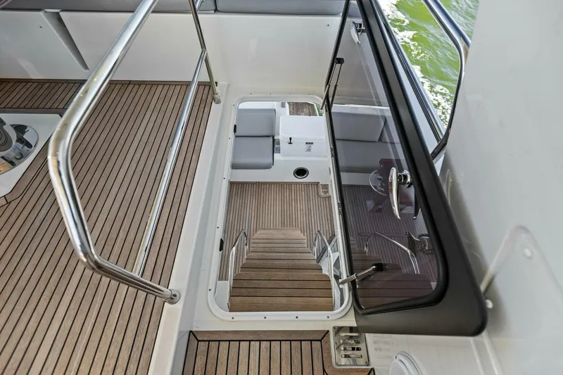 Radiant Yacht Photos Pics Staircase on 2019 Prestige 630 Flybridge yacht with wooden flooring and sleek design.