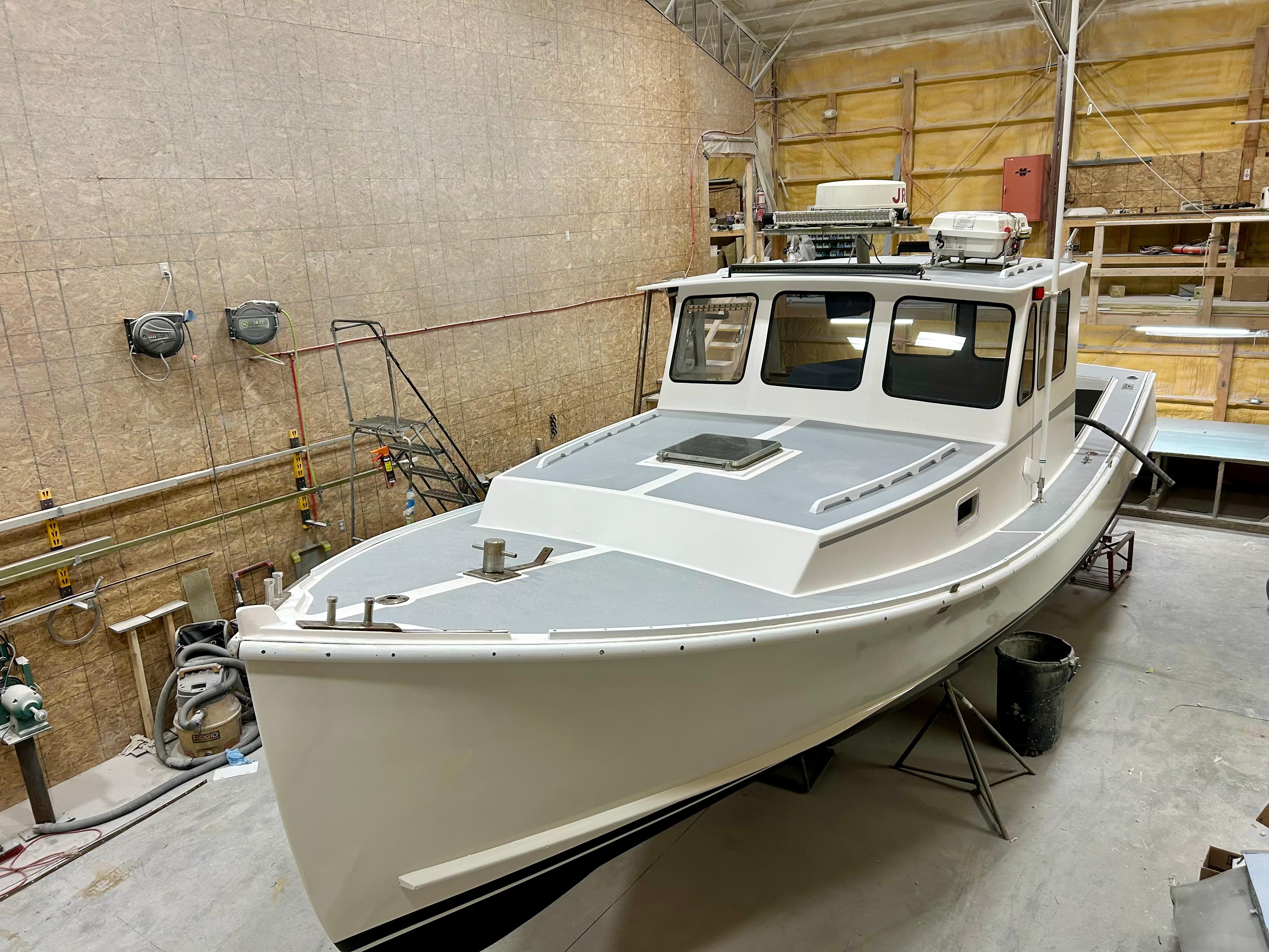 1980 Holland 32 boat in a workshop, showcasing classic design and craftsmanship.