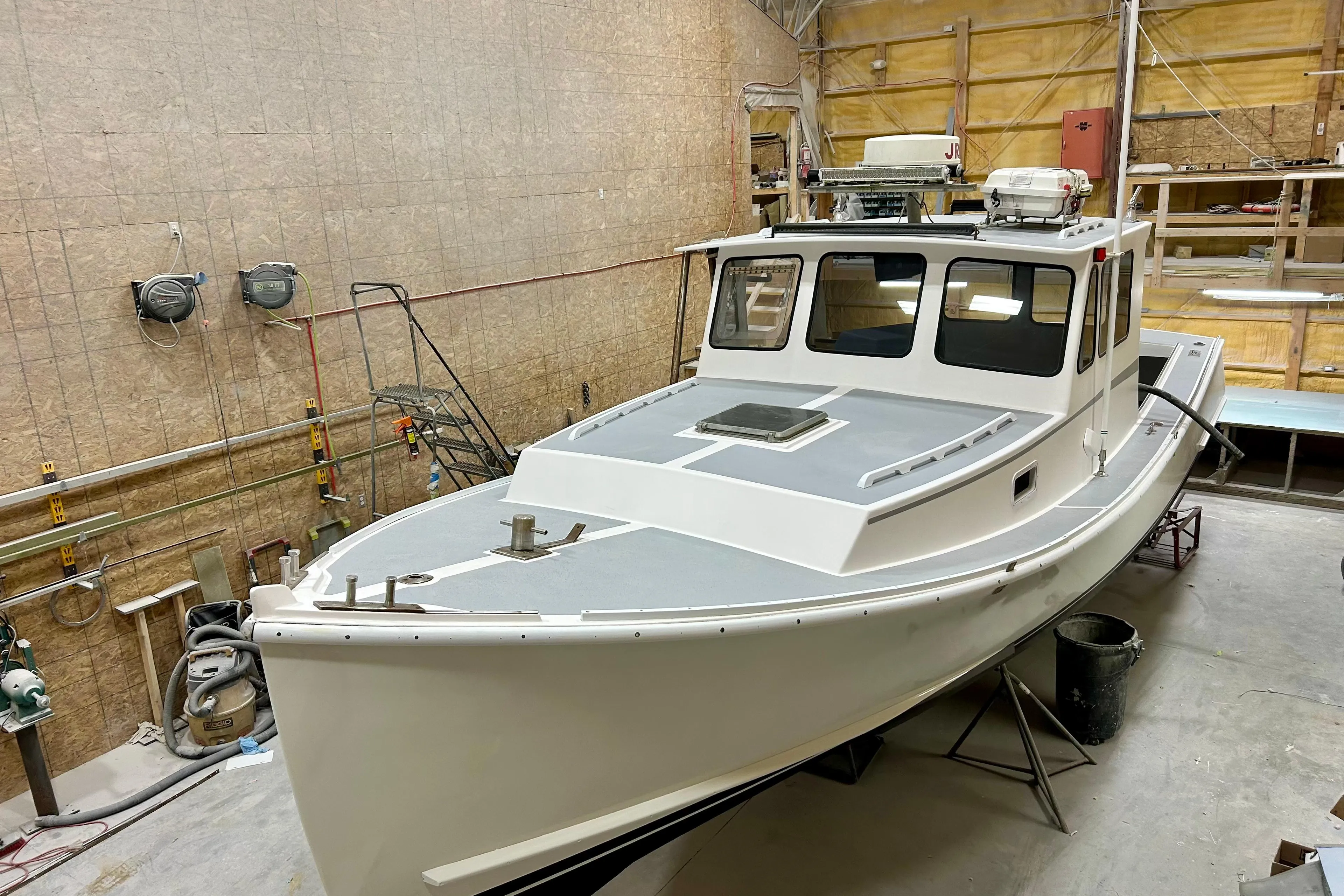 1980 Holland 32 boat in a workshop, showcasing classic design and craftsmanship.