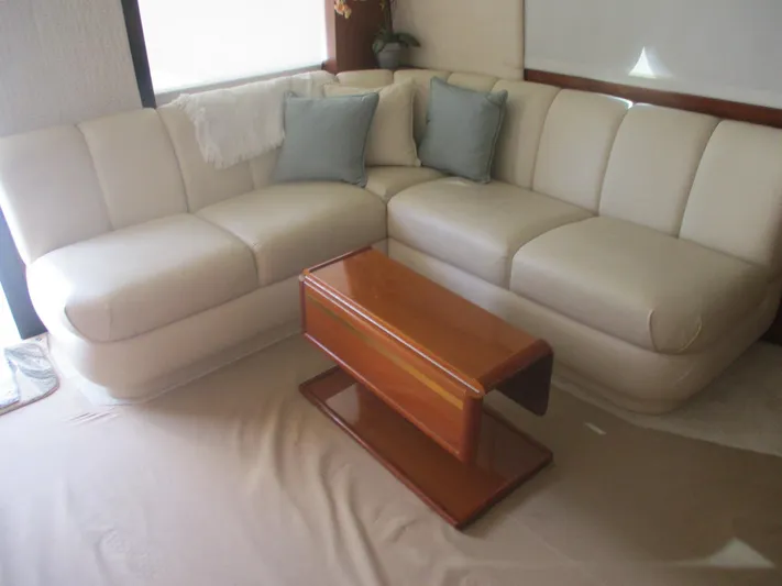Persian Lady Yacht Photos Pics Luxurious interior of 1997 Ocean Yachts 40 Super Sport with cream sofa and wooden table.