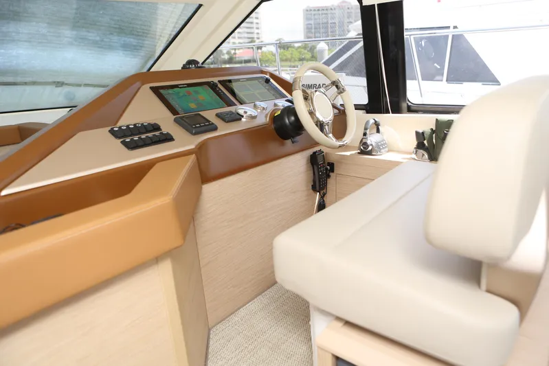 Integrity Yacht Photos Pics 2017 Beneteau Monte Carlo 4 helm with modern controls and beige seating.
