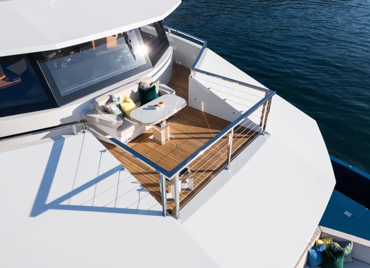 King Benji Yacht Photos Pics Luxurious Dunya Yachts 2024 model with elegant deck seating overlooking the ocean.