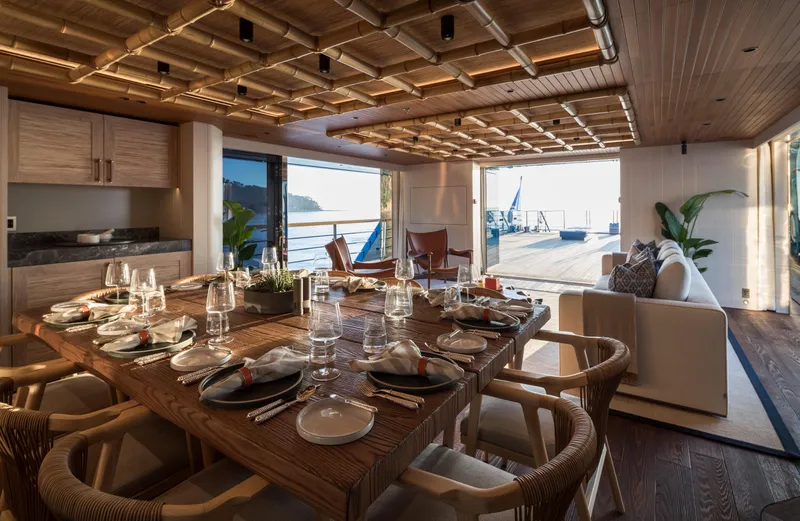 King Benji Yacht Photos Pics Luxurious dining area on 2024 Dunya Yacht, featuring elegant table setting and ocean view.