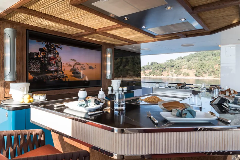 King Benji Yacht Photos Pics Luxurious dining area on 2024 Dunya Yacht with elegant table setting and scenic view.
