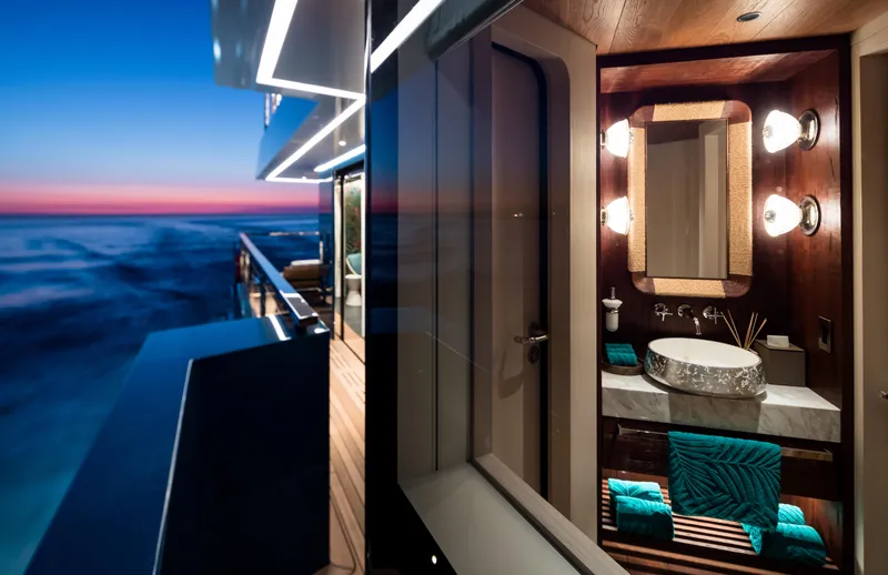 King Benji Yacht Photos Pics Luxurious 2024 Dunya Yacht interior with elegant bathroom and stunning ocean view at sunset.