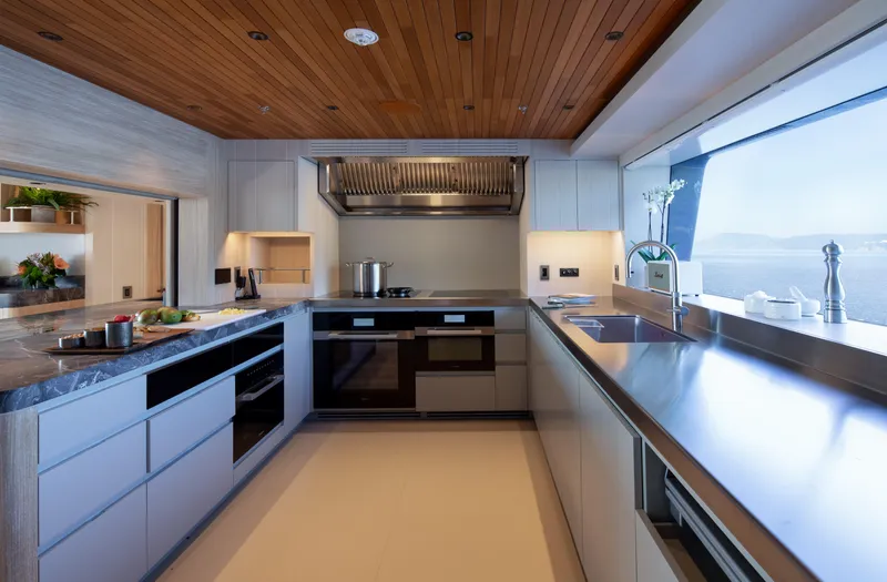 King Benji Yacht Photos Pics Luxurious kitchen interior on 2024 Dunya Yachts, featuring modern appliances and ocean view.