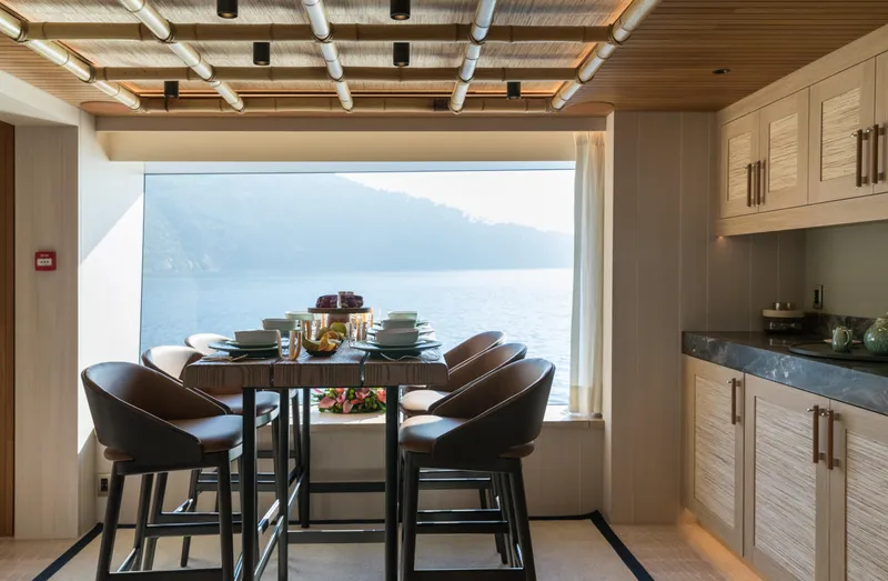 King Benji Yacht Photos Pics Luxurious dining area on 2024 Dunya Yacht with ocean view and elegant furnishings.