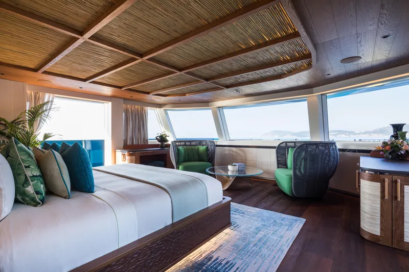 King Benji Yacht Photos Pics Luxurious interior of 2024 Dunya Yachts, featuring elegant bedroom with panoramic windows.