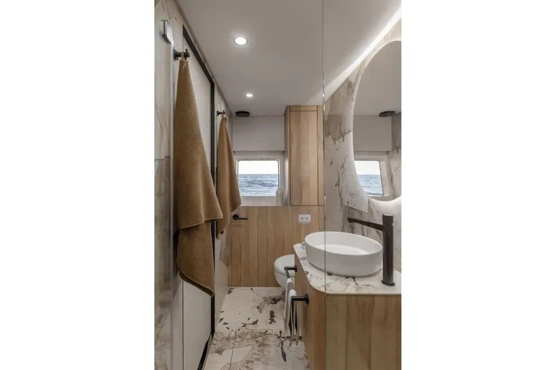 Moon 60 Power Arctic Moon Yacht Photos Pics Luxurious yacht bathroom with modern design, featuring marble accents and ocean view windows. Moon 60 Power 2025.