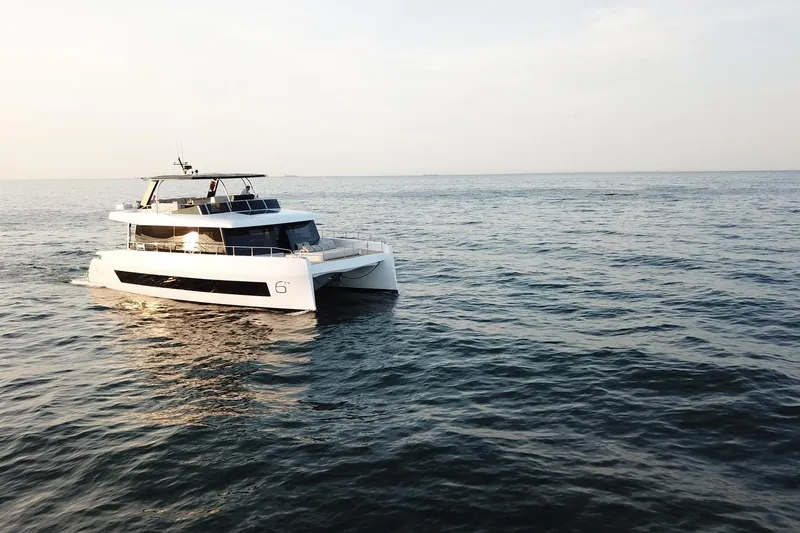 Moon 60 Power Arctic Moon Yacht Photos Pics 2025 Moon 60 Power yacht cruising on open sea at sunset.