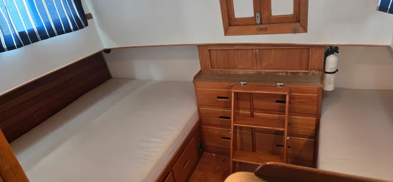 Interlude Yacht Photos Pics 1987 Grand Banks 36 Classic cabin with twin beds and wooden cabinetry.