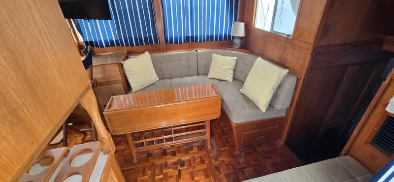 Interlude Yacht Photos Pics Interior of 1987 Grand Banks 36 Classic with cozy seating and wooden accents.