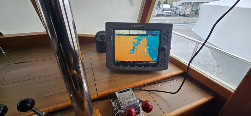 Interlude Yacht Photos Pics Navigation system on 1987 Grand Banks 36 Classic boat dashboard, displaying nautical chart.