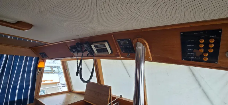 Interlude Yacht Photos Pics Interior view of 1987 Grand Banks 36 Classic boat with control panel and wooden finish.