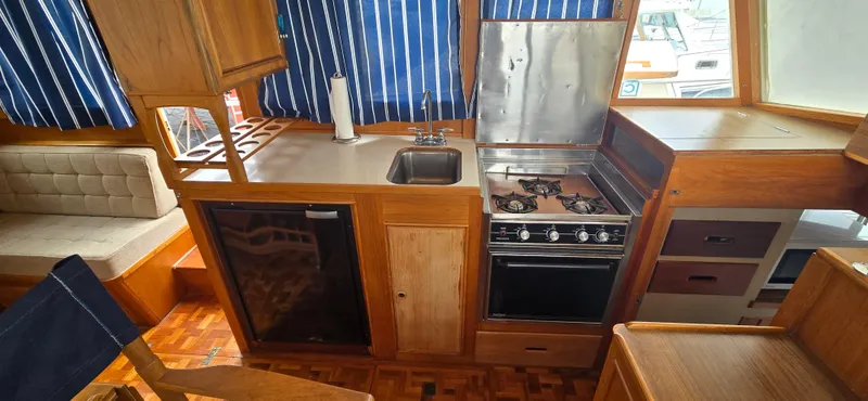 Interlude Yacht Photos Pics Interior of 1987 Grand Banks 36 Classic yacht with kitchen and seating area.