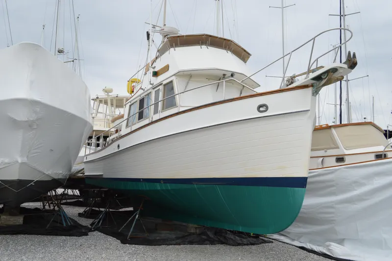 Interlude Yacht Photos Pics 1987 Grand Banks 36 Classic yacht on dry dock, white hull with green bottom.