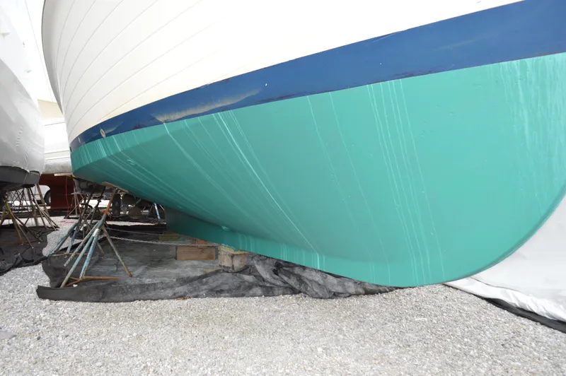 Interlude Yacht Photos Pics 1987 Grand Banks 36 Classic boat hull on dry dock, green and blue paint visible.
