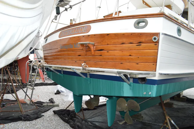 Interlude Yacht Photos Pics 1987 Grand Banks 36 Classic boat on dry dock, showcasing wooden stern and dual propellers.