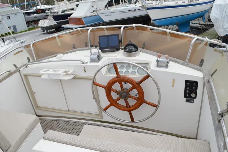 Interlude Yacht Photos Pics Helm of 1987 Grand Banks 36 Classic yacht with wooden wheel and navigation equipment.
