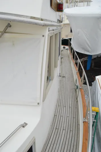 Interlude Yacht Photos Pics 1987 Grand Banks 36 Classic yacht deck with wooden flooring and white exterior.