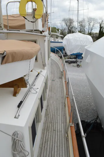 Interlude Yacht Photos Pics 1987 Grand Banks 36 Classic yacht with wooden deck, docked alongside other boats.