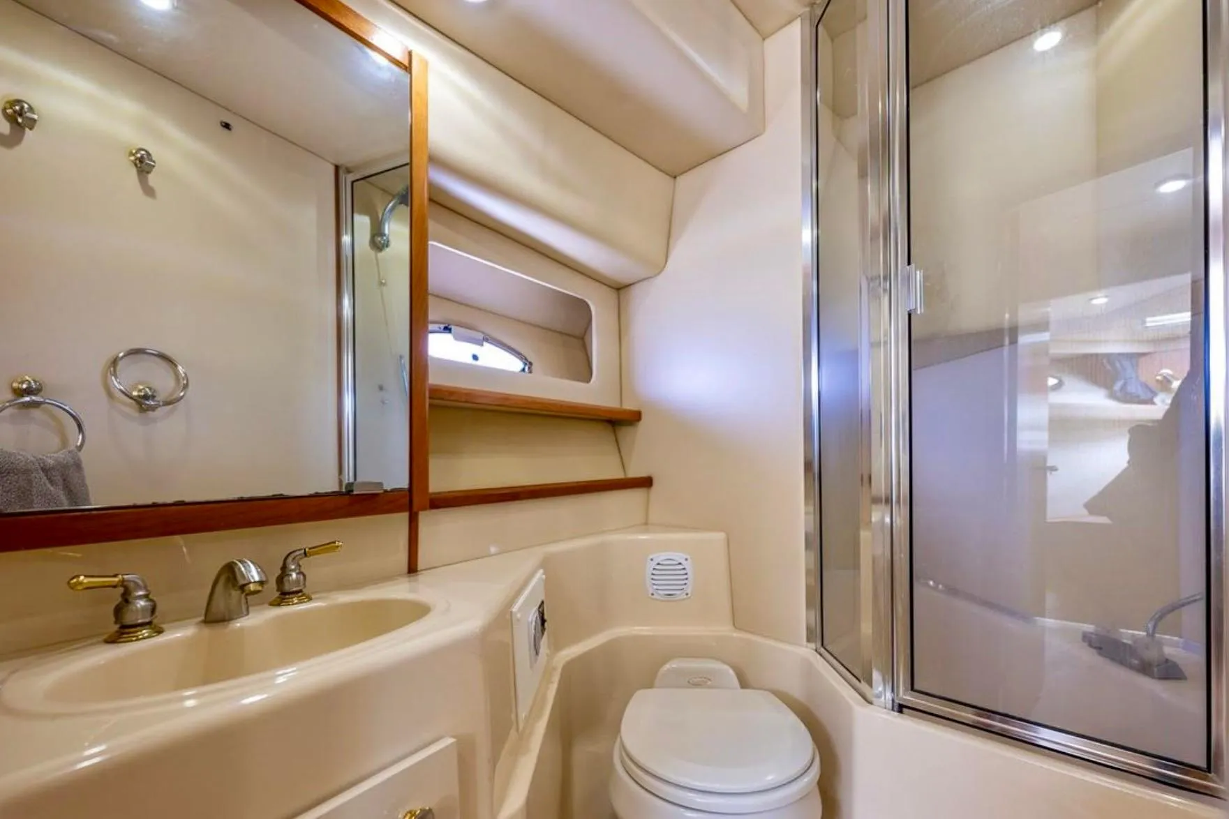 Luxurious bathroom in 2004 Meridian 490 Pilothouse yacht with shower and vanity.