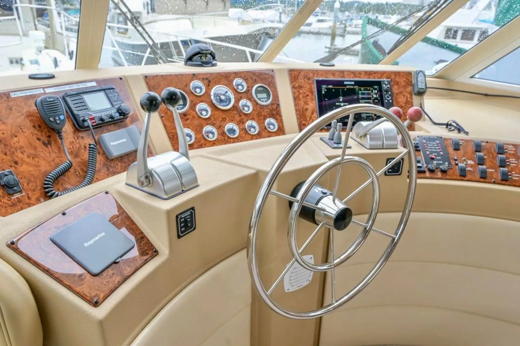 2004 Meridian 490 Pilothouse helm with steering wheel, controls, and navigation equipment.
