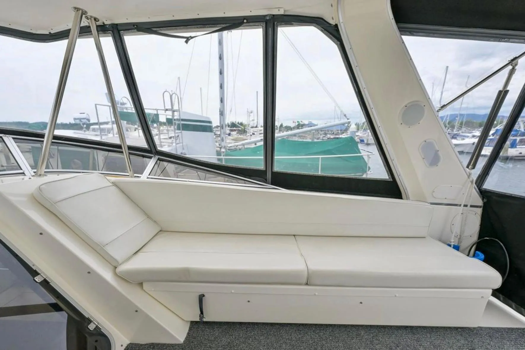 2004 Meridian 490 Pilothouse interior with white seating and marina view.