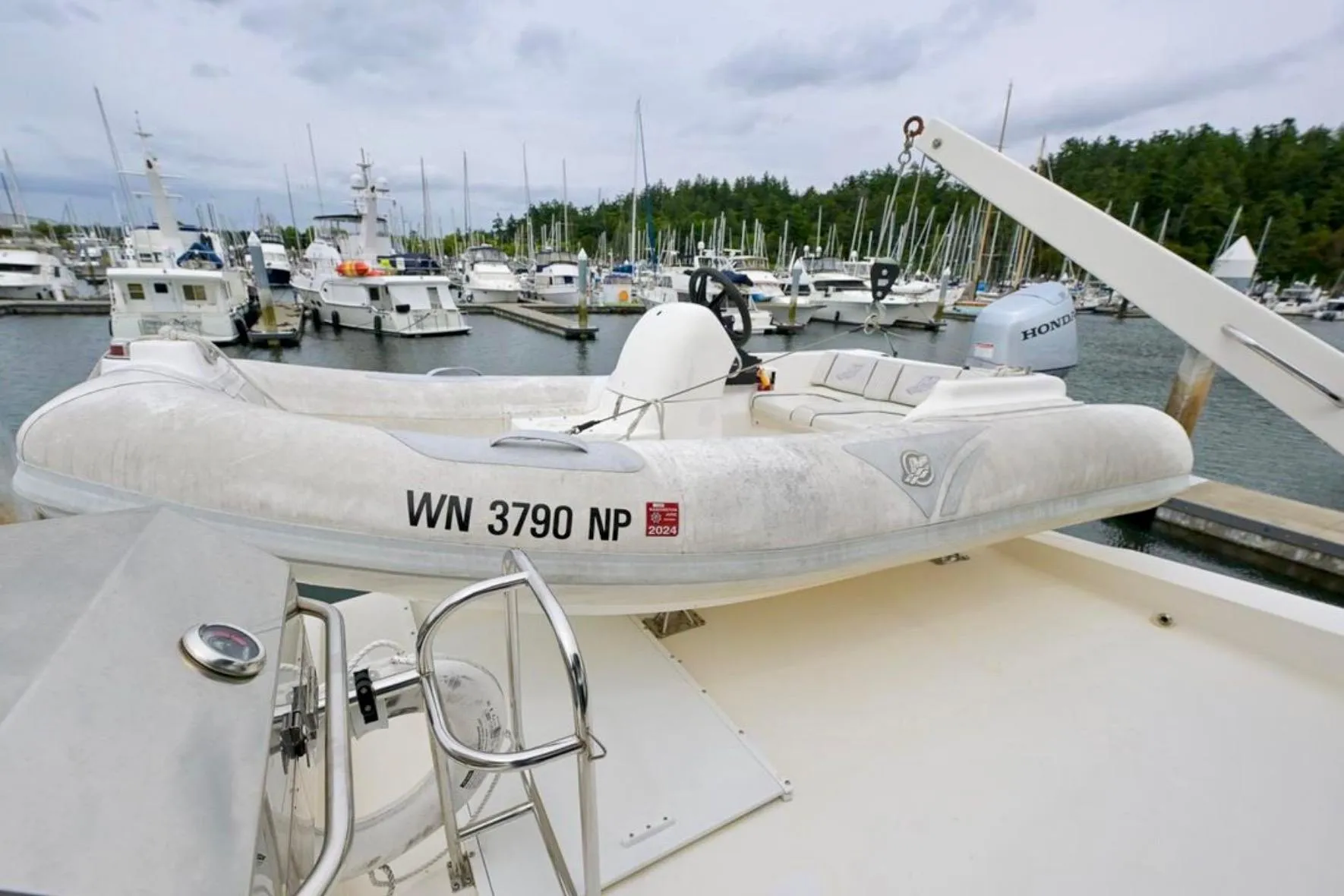 Inflatable boat on 2004 Meridian 490 Pilothouse, docked at marina with other vessels.
