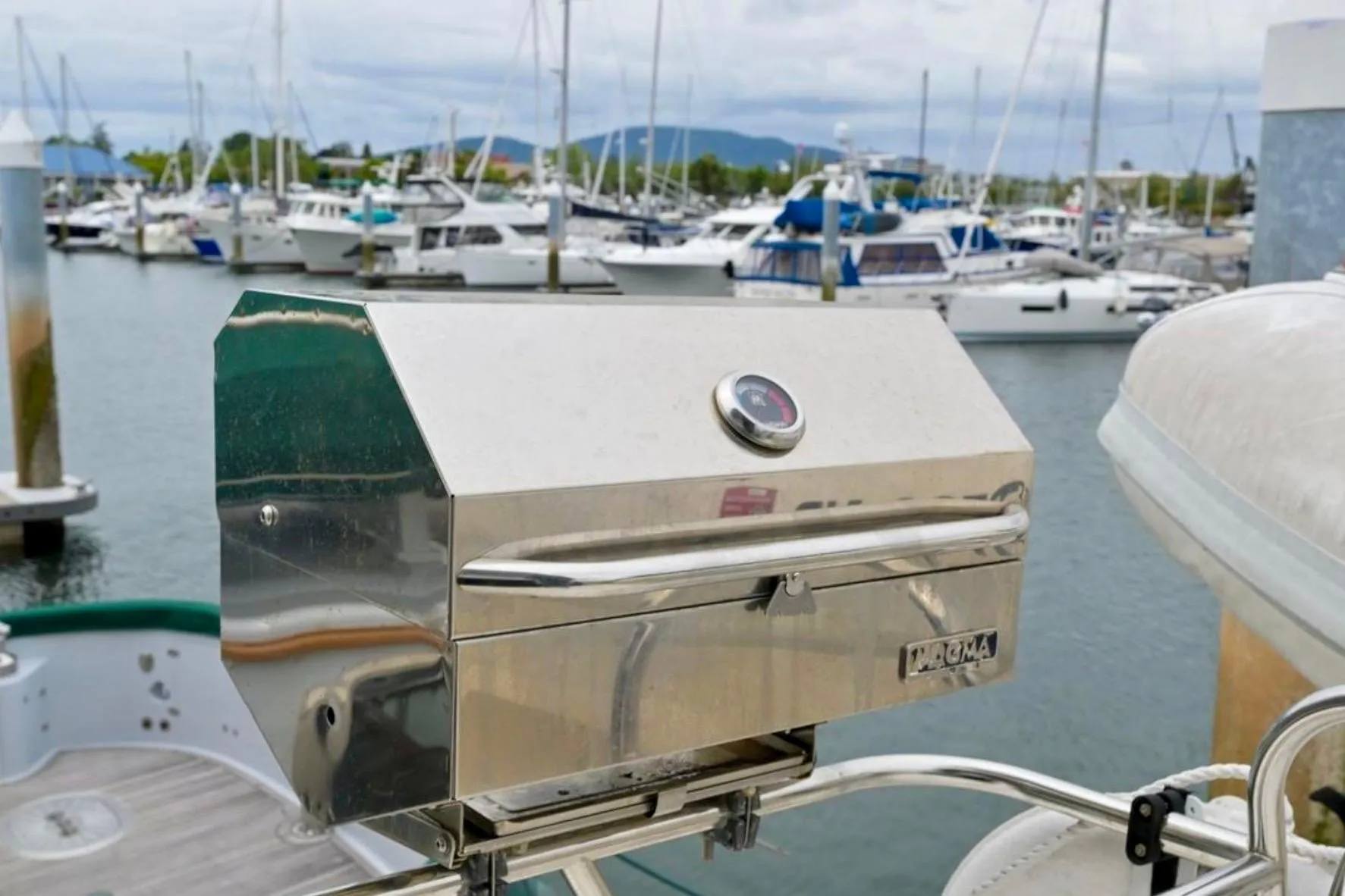Stainless steel grill on a 2004 Meridian 490 Pilothouse yacht in a marina.