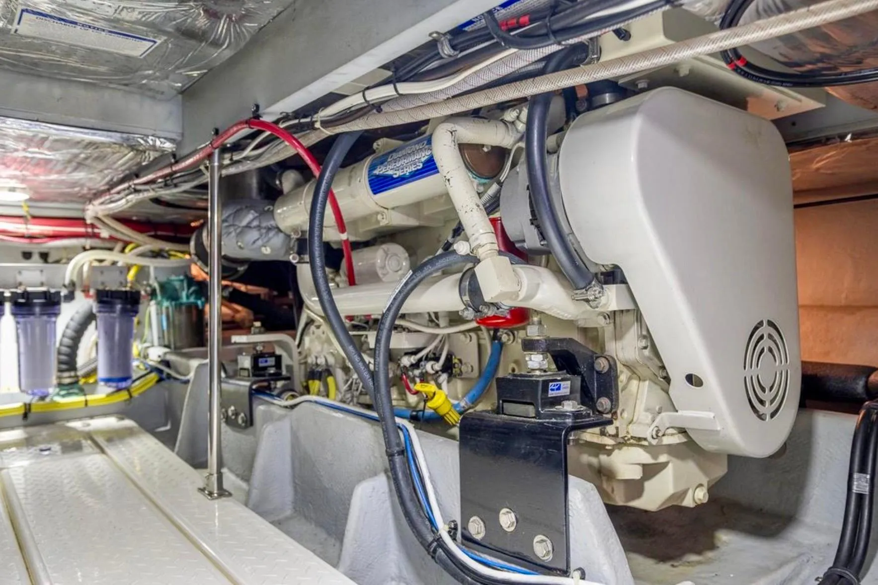 Engine room of 2004 Meridian 490 Pilothouse with visible machinery and wiring.