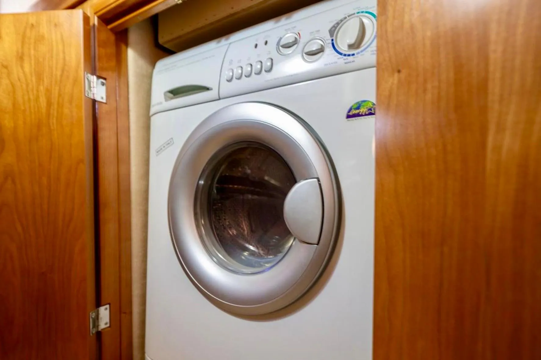 Washing machine inside 2004 Meridian 490 Pilothouse wooden cabinet.