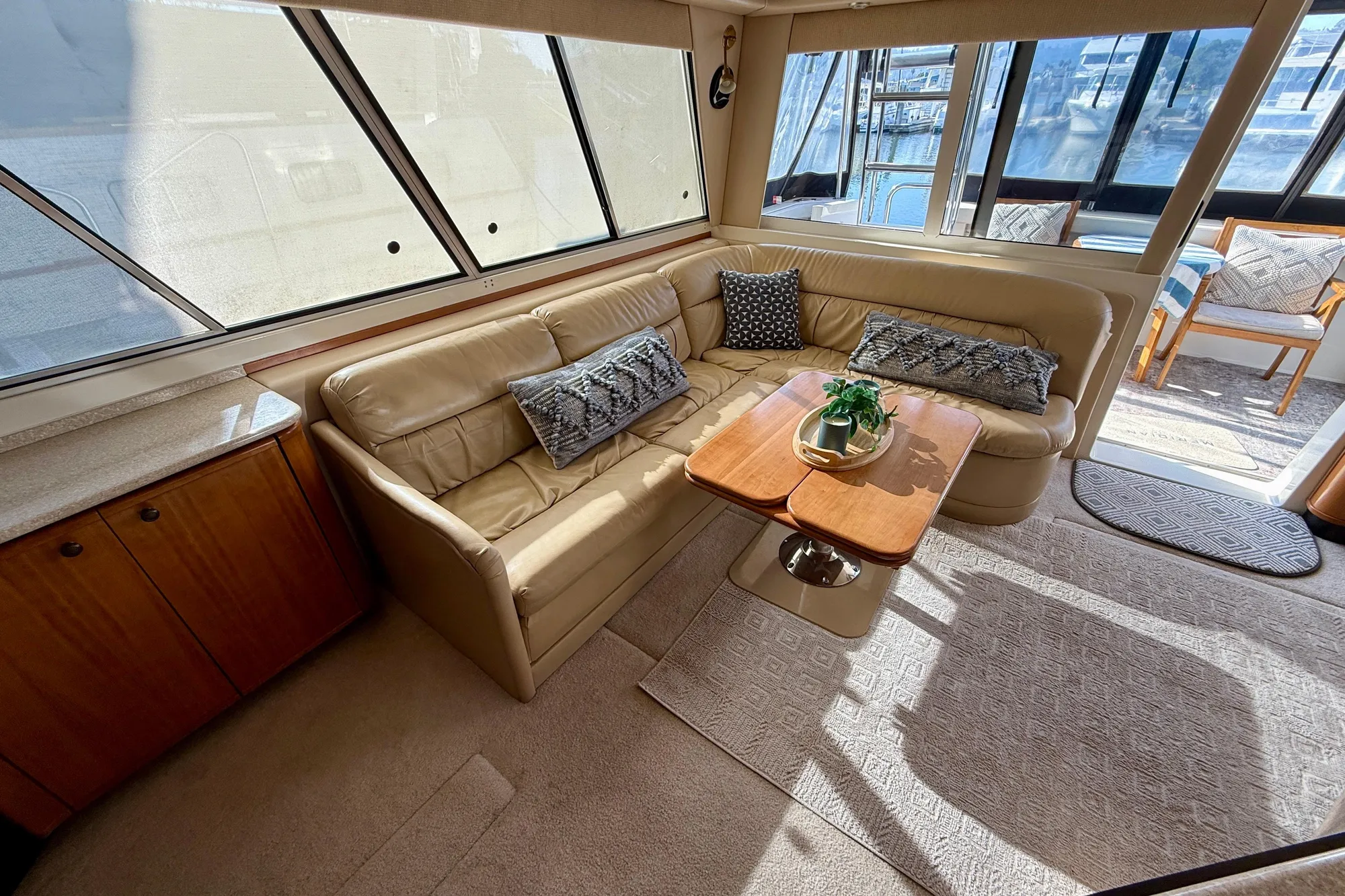 Luxurious interior of 2004 Meridian 490 Pilothouse yacht with plush seating and elegant decor.