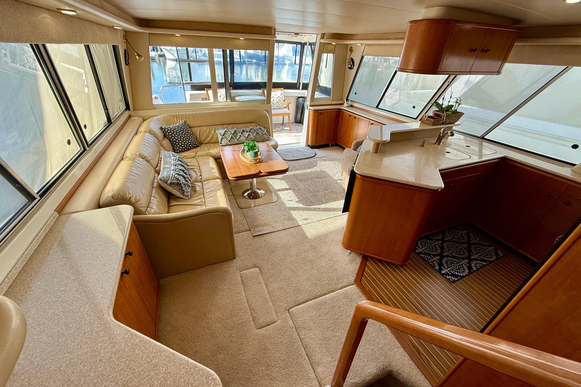 Luxurious interior of a 2004 Meridian 490 Pilothouse yacht with elegant seating and kitchen area.