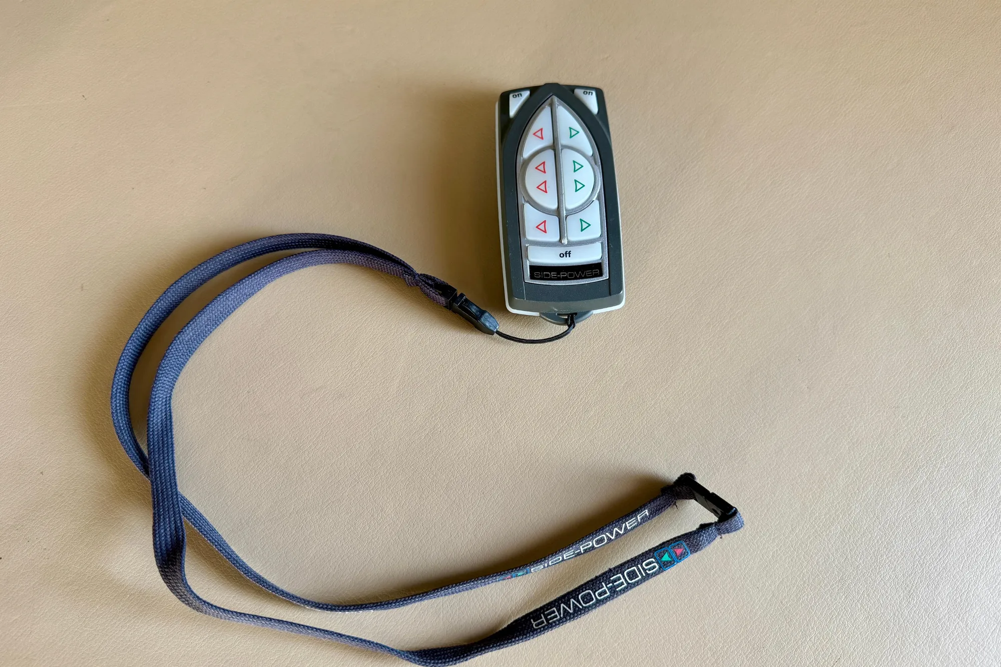 Remote control for 2004 Meridian 490 Pilothouse, featuring Side-Power branding and lanyard.