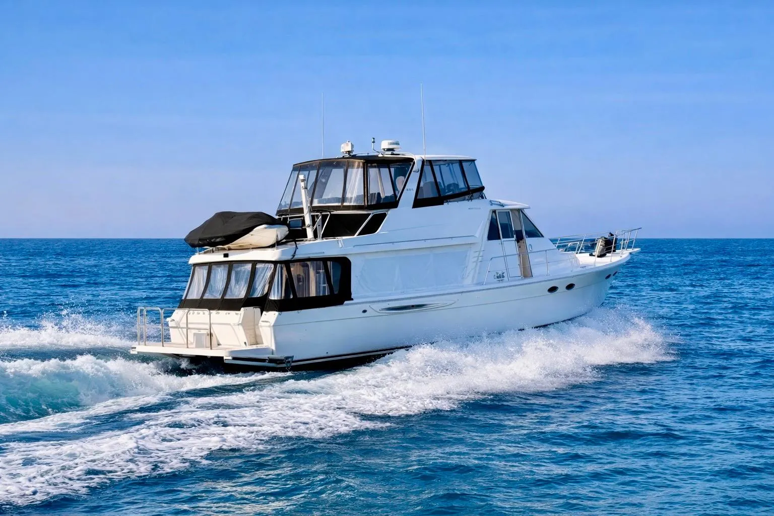 2004 Meridian 490 Pilothouse yacht cruising on open blue sea.