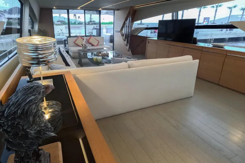 Honey Badger Yacht Photos Pics Luxurious interior of a 2012 Pershing 92 yacht with modern decor and large windows.