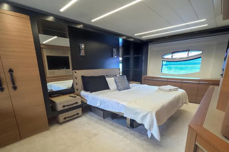 Honey Badger Yacht Photos Pics Luxurious bedroom interior on a 2012 Pershing 92 yacht with ocean view.