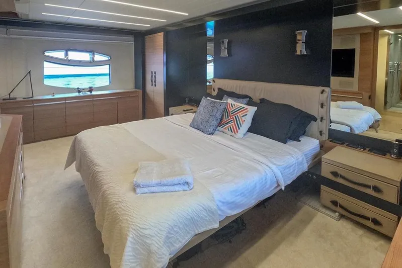 Honey Badger Yacht Photos Pics Luxurious bedroom interior of 2012 Pershing 92 yacht with ocean view window.