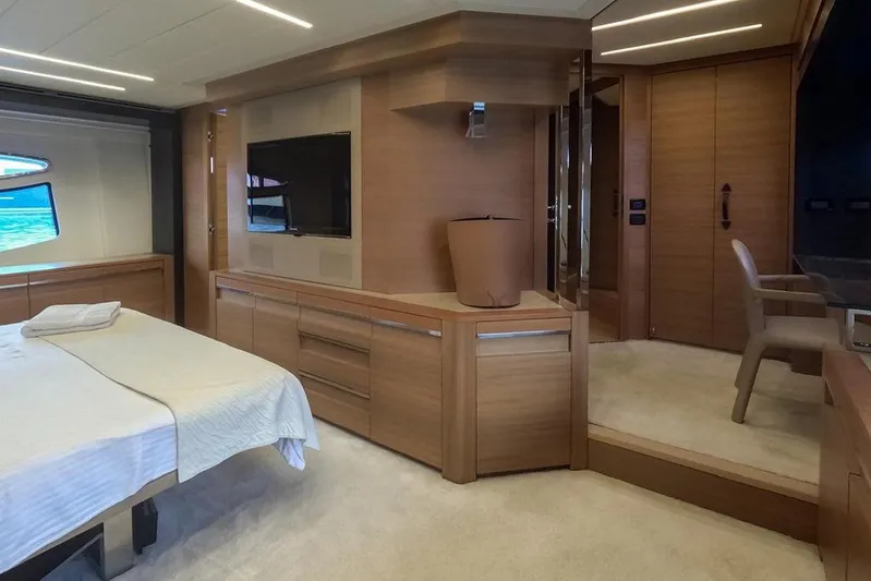 Honey Badger Yacht Photos Pics Luxurious interior of 2012 Pershing 92 yacht with modern wood finishes and elegant furnishings.
