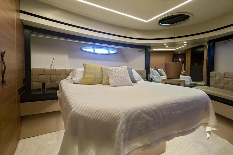 Honey Badger Yacht Photos Pics Luxurious bedroom interior of 2012 Pershing 92 yacht with modern design and elegant furnishings.