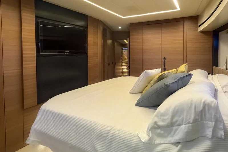 Honey Badger Yacht Photos Pics Luxurious bedroom interior on a 2012 Pershing 92 yacht with modern design elements.
